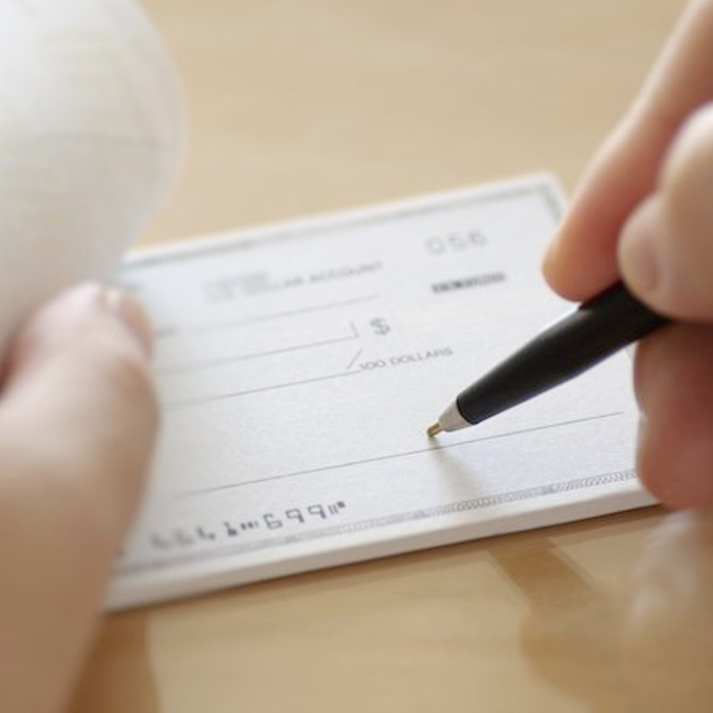 A person writing a check