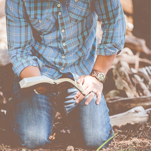 Man Kneeling with a Bible